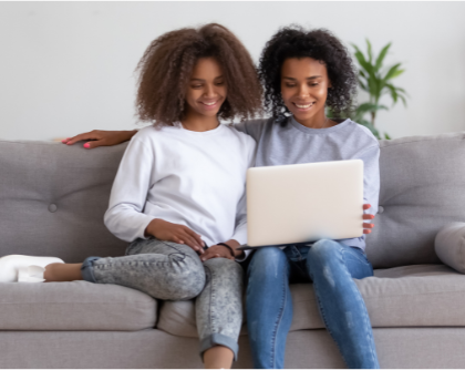 A parent and student researching scholarships together at home