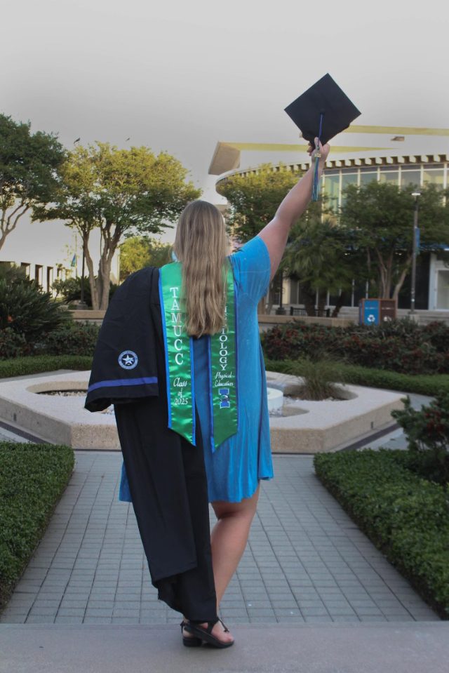 Janice's daughter celebrating her debt-free graduation, raising her cap — TAMUCC Class of 2025