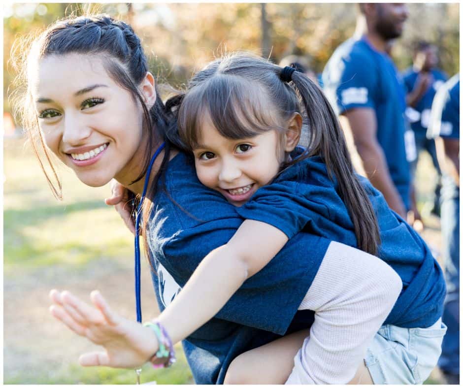 student volunteering at summer camp