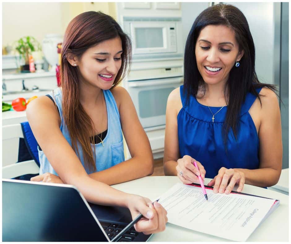 mother helping daughter go through college applications