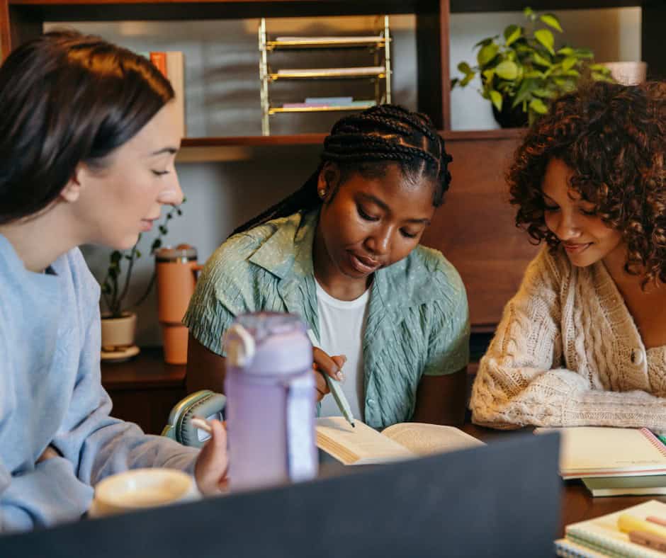 students sitting at a shared desk planning for college