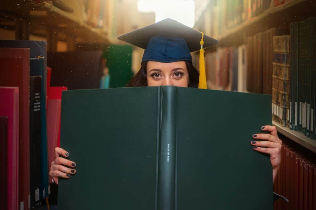 student in library reading books