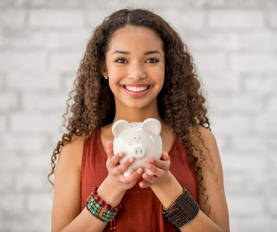 female teenager with piggy bank