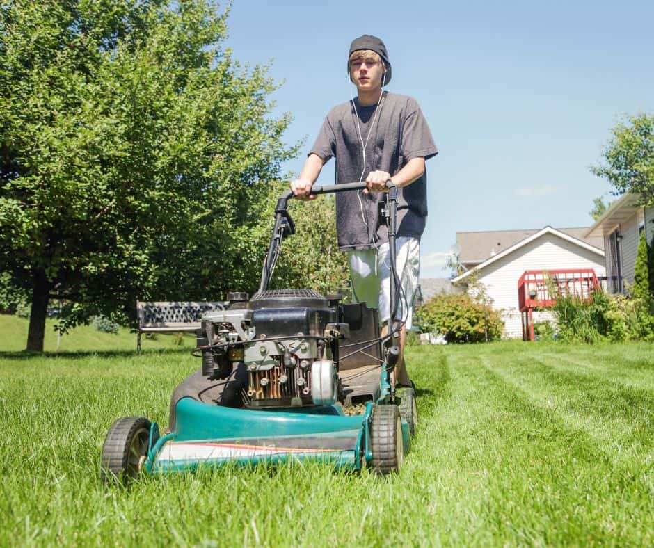 teen mowing the lawn