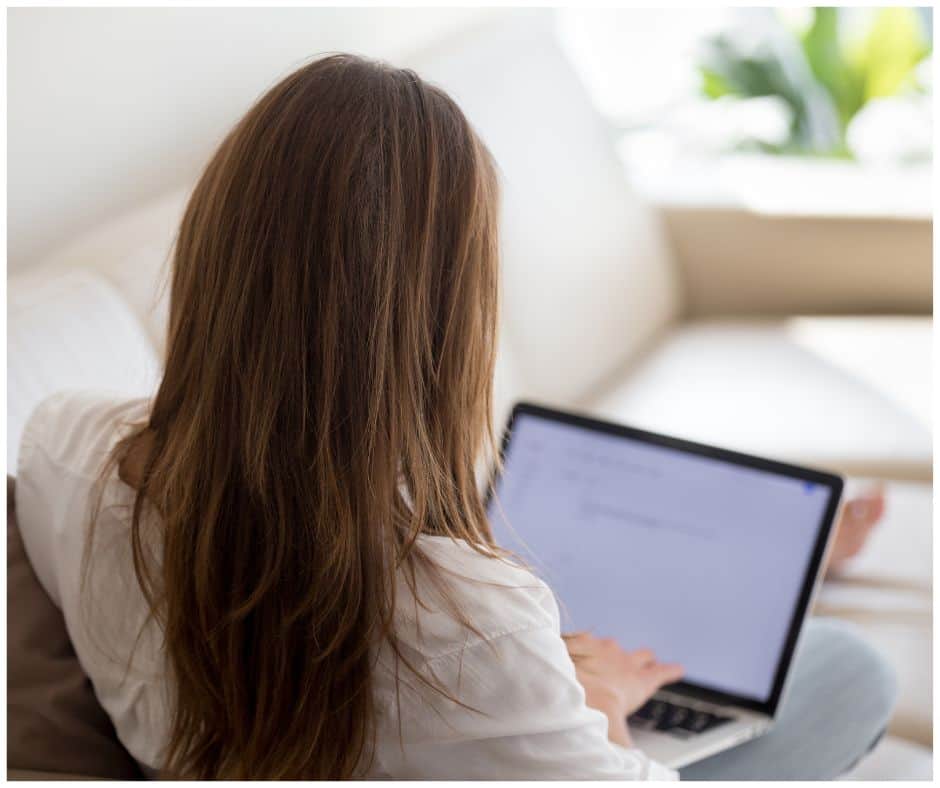 female student writing a cover letter on laptop