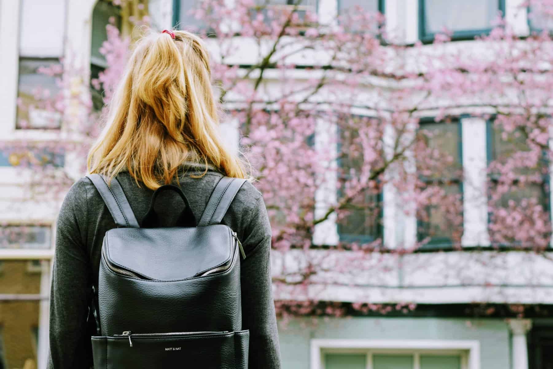 female student in front of university