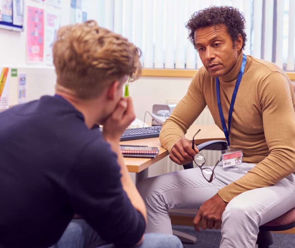 male college student speaking with a campus counsellor about mental health issues